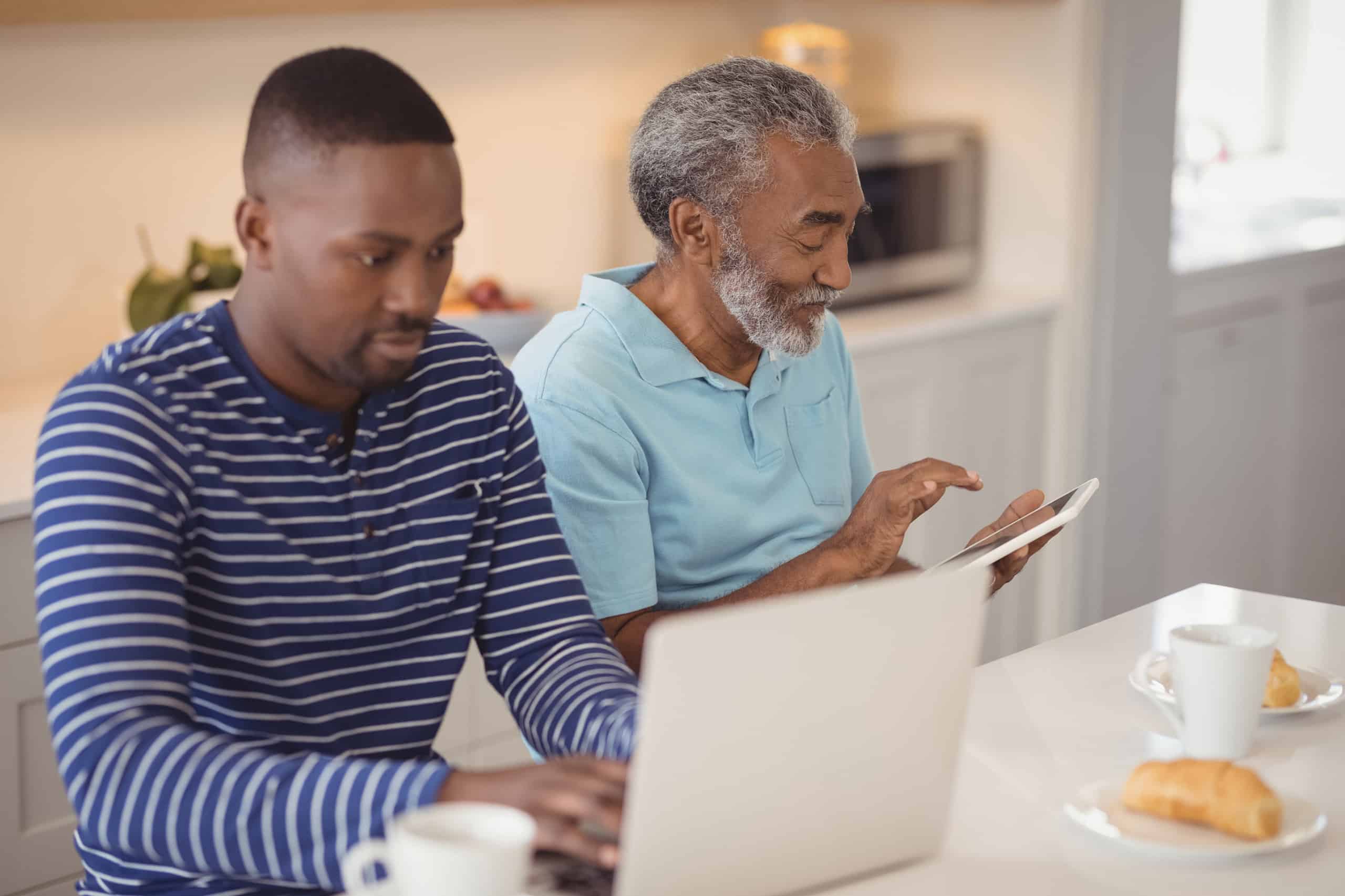 Father and son on electronic devices