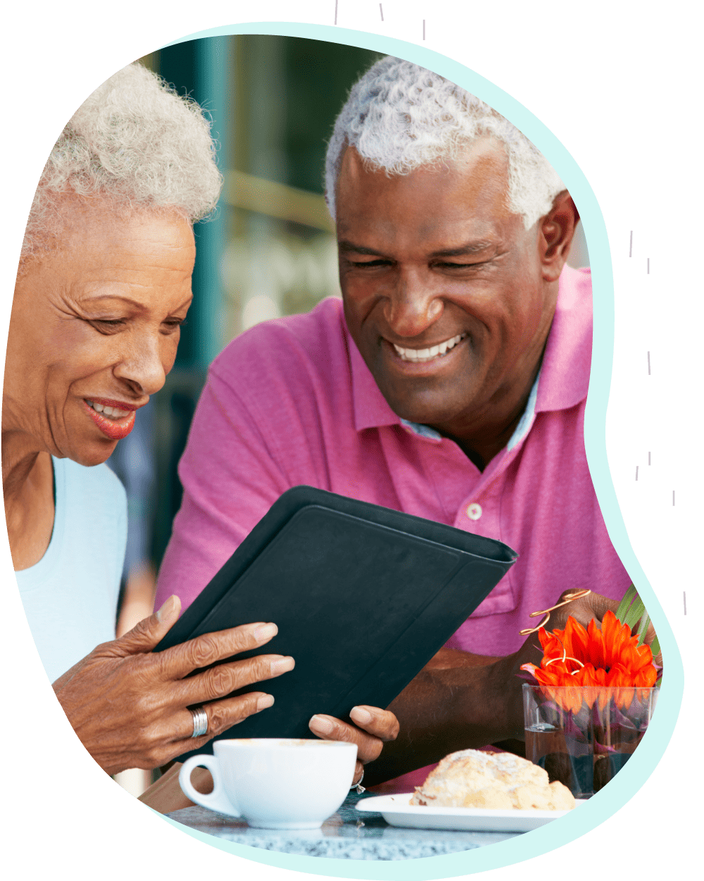 Senior couple at lunch using tablet