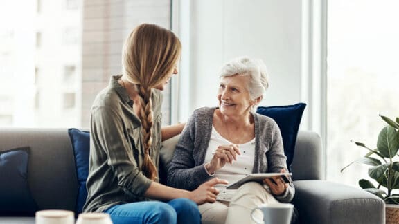 Senior lady with daughter researching senior living